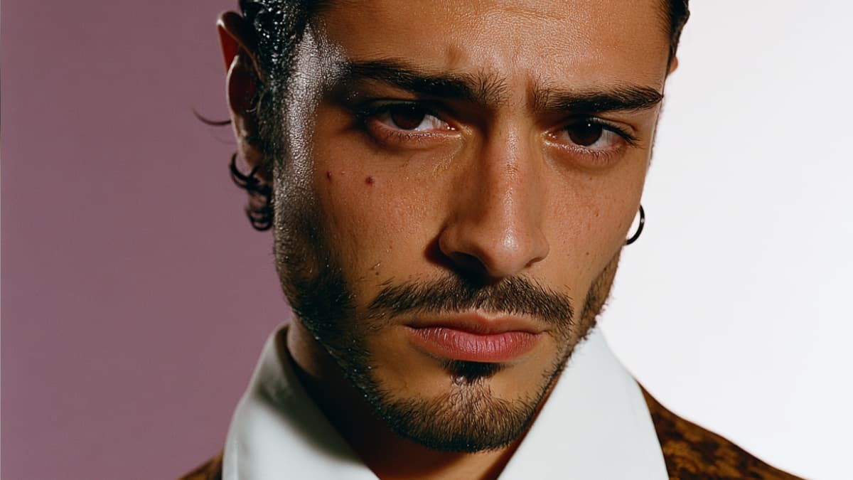 Prominent close-up portrait of a man with an intense gaze, defined brows, and smooth, irritation-free skin, representing professional men's grooming. Visual concept highlighting how specialized men's waxing services eliminate razor bumps, irritation, and ingrown hairs, offering precise and impeccably tailored results.
